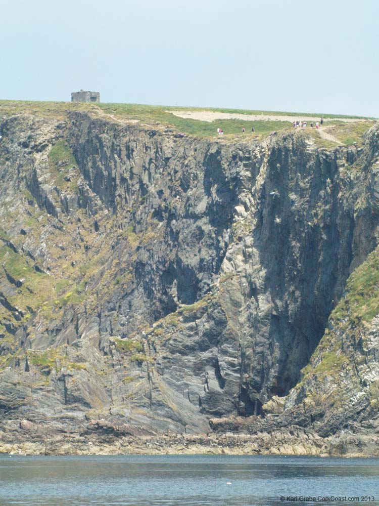 KG091827 tower people cliffs water